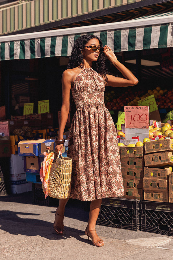 Woman in palm tree motif dress.