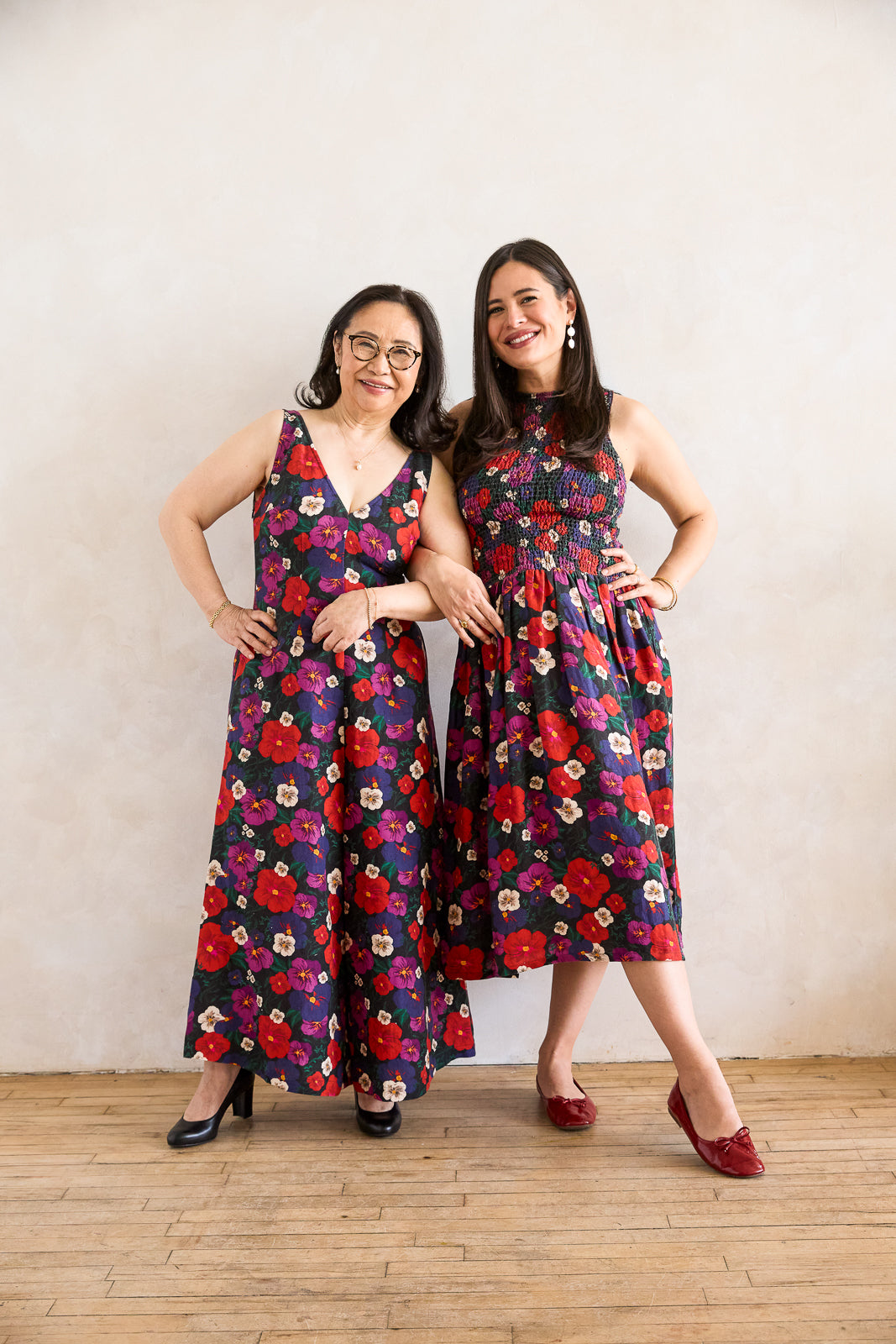 Mother and daughter in matching pansy jumpsuit and dress.