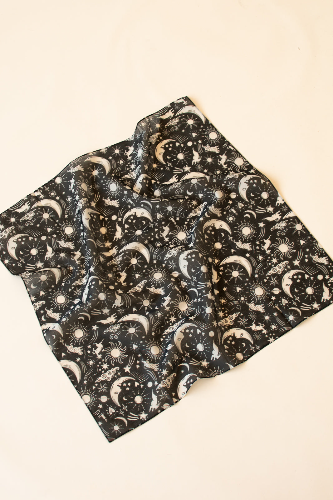 scarf with celestial pattern on a beige background